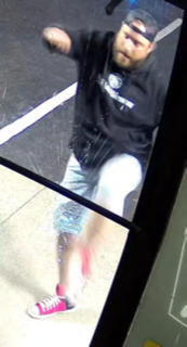 Person wearing a black hoodie and jeans, pink and white sneakers