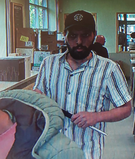 Man in striped shirt and baseball cap.