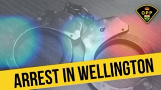 Handcuffs with a yellow banner reading ARREST IN WELLINGTON