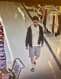 Person walking down a store aisle