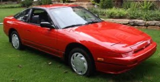Red Nissan 300ZX coupe on grass