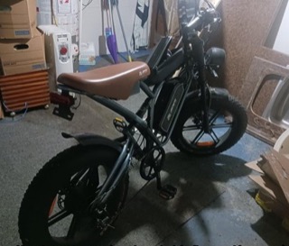Electric bike with fat tires and a brown seat.
