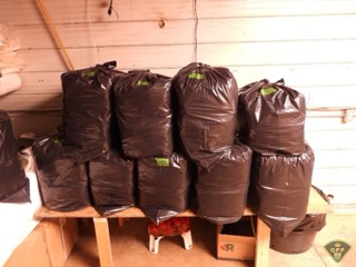 Black plastic bags stacked on a wooden pallet