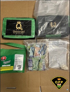 Packages of cannabis, stacks of Canadian twenty-dollar bills, and a knife.