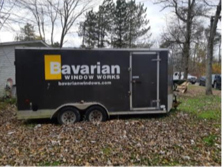 Black trailer with &quot;Bavarian Window Works bavarianwindows.com&quot;