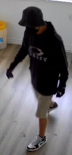 Person wearing a black hoodie and khaki shorts