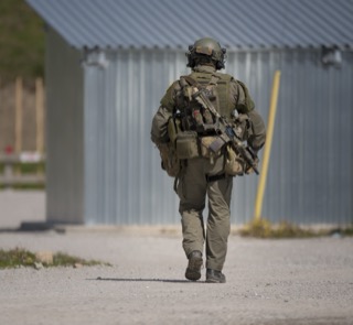 Person in tactical gear walking away