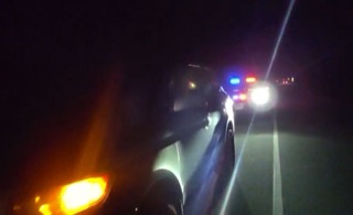 Blue and red flashing lights, headlights, dark road