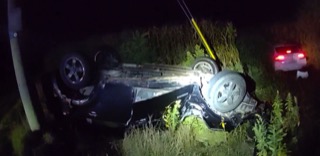 Vehicle overturned in tall grass.