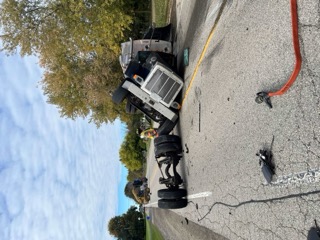 Semi-truck overturned on its side.
