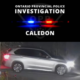 OPP investigation. Black SUV with flashing red and blue lights.