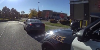 Police car with a black car parked ahead.