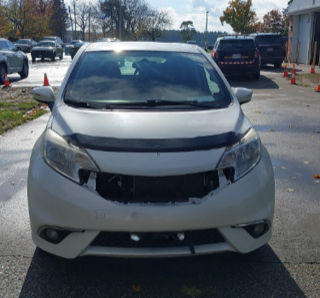 Damaged white hatchback