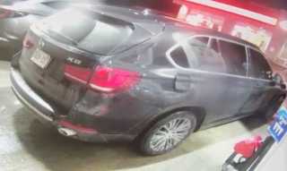 Black SUV parked at a gas station