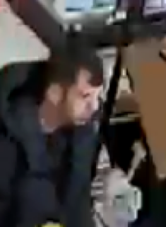 Man in black shirt looking down
