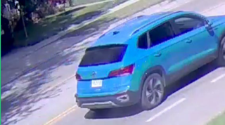Blue SUV driving on a road