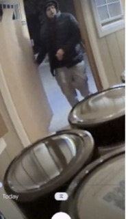 Person wearing a black hoodie and khaki pants