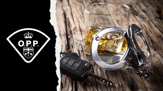 Handcuffs, car key, glass of whiskey