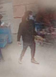 Person in dark clothing standing.