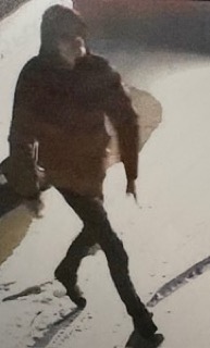 Person walking, dark clothing, blurry