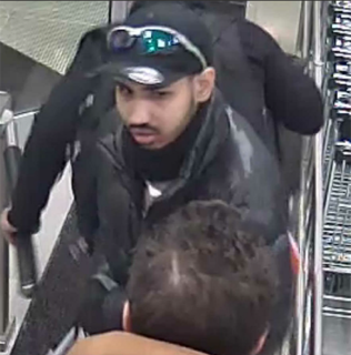 Man wearing a black hoodie and sunglasses