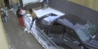 Person on top of a snow-covered van.