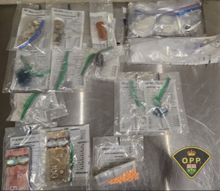Plastic bags with needles and orange pills.