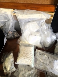 White pills in clear plastic bags.