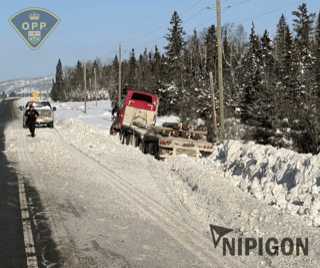 Semi-truck overturned in snow, officer observing