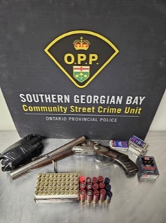 Two shotguns, ammunition, and drug packaging on a black background.