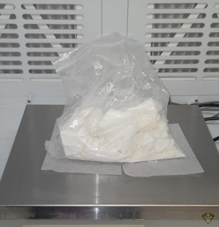 White powder in a clear plastic bag on a scale
