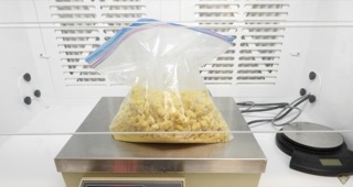 White crystals in a clear plastic bag on a scale