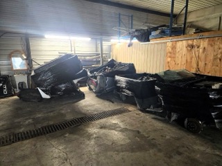 Crushed black car, visible damage