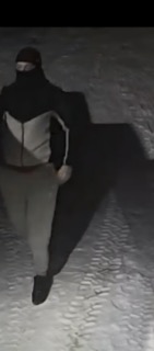 Person in dark clothing, partially obscured by shadow.