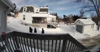 Three people walking through deep snow.