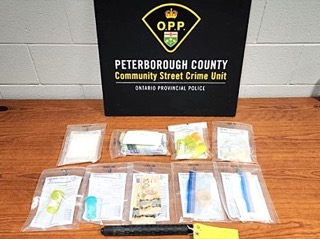 Peterborough County Community Street Crime Unit Ontario Provincial Police. Several small baggies containing a white substance and Canadian currency.