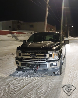 Black pickup truck in snow.