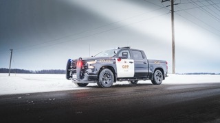 Black OPP pickup truck on a snowy road
