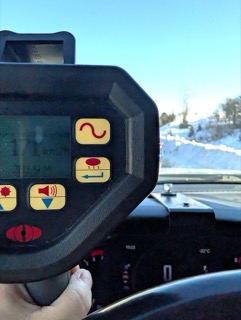 Dashboard with snow-covered mountains visible through windshield