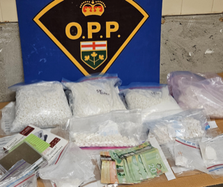 Pile of white pills, Canadian money, small plastic bags, OPP logo