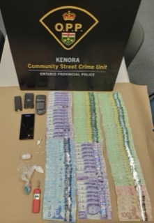 Stacked Canadian currency and drugs.