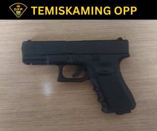 Toy handgun on a wooden surface