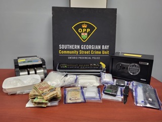 Stacked Canadian banknotes, drug scales, baggies, and a money counter.