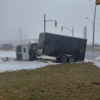 Truck and trailer off the road, snowy conditions