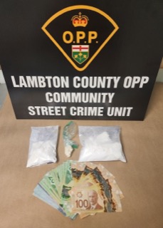 Street Crime Unit, Lambton County OPP, Canada. Packages of suspected drugs and Canadian currency.