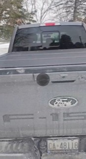 Dark pickup truck, rear view, license plate reads CA 48118