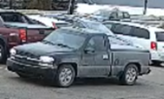 Gray pickup truck covered in snow