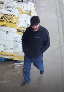 Man walking past stacked pallets