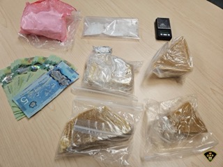 Canadian five-dollar bill, small baggies, black device