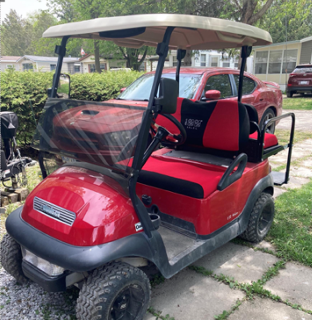 Red golf cart with black seat covers
